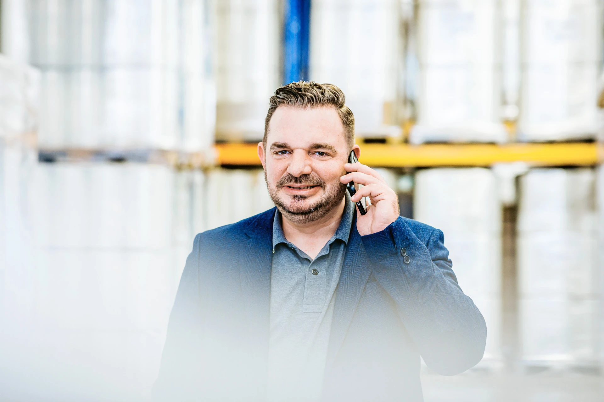 Vertriebsleiter Daniel Hallerbach beim Telefonieren in der Lagerhalle 